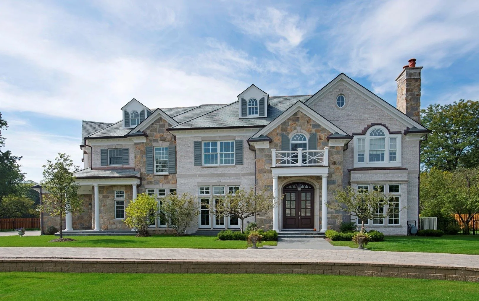 Finished SGE residence framed by lawn and mature landscaping.