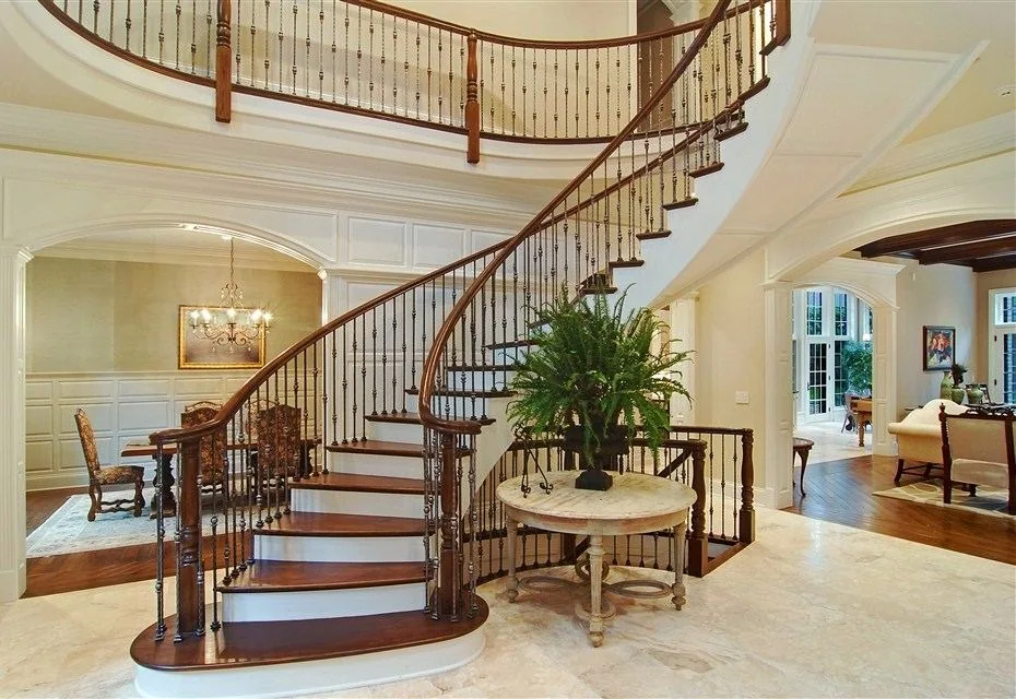 Curving stair and double-height foyer from the SGE project archive.
