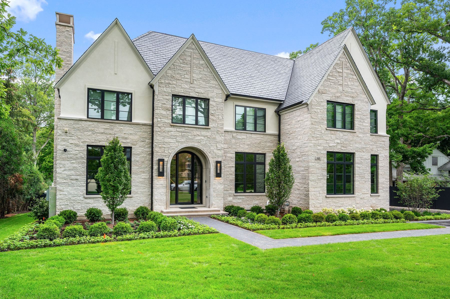 Finished front three-quarter view of the Franklin Residence in Glencoe, showing the completed house, entry and landscape.